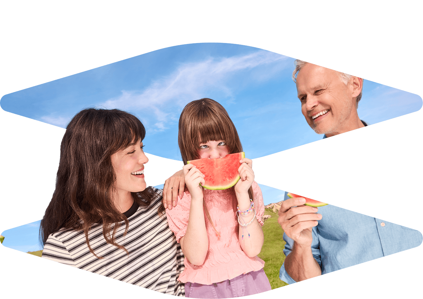 Family enjoying watermelon slices outdoors.