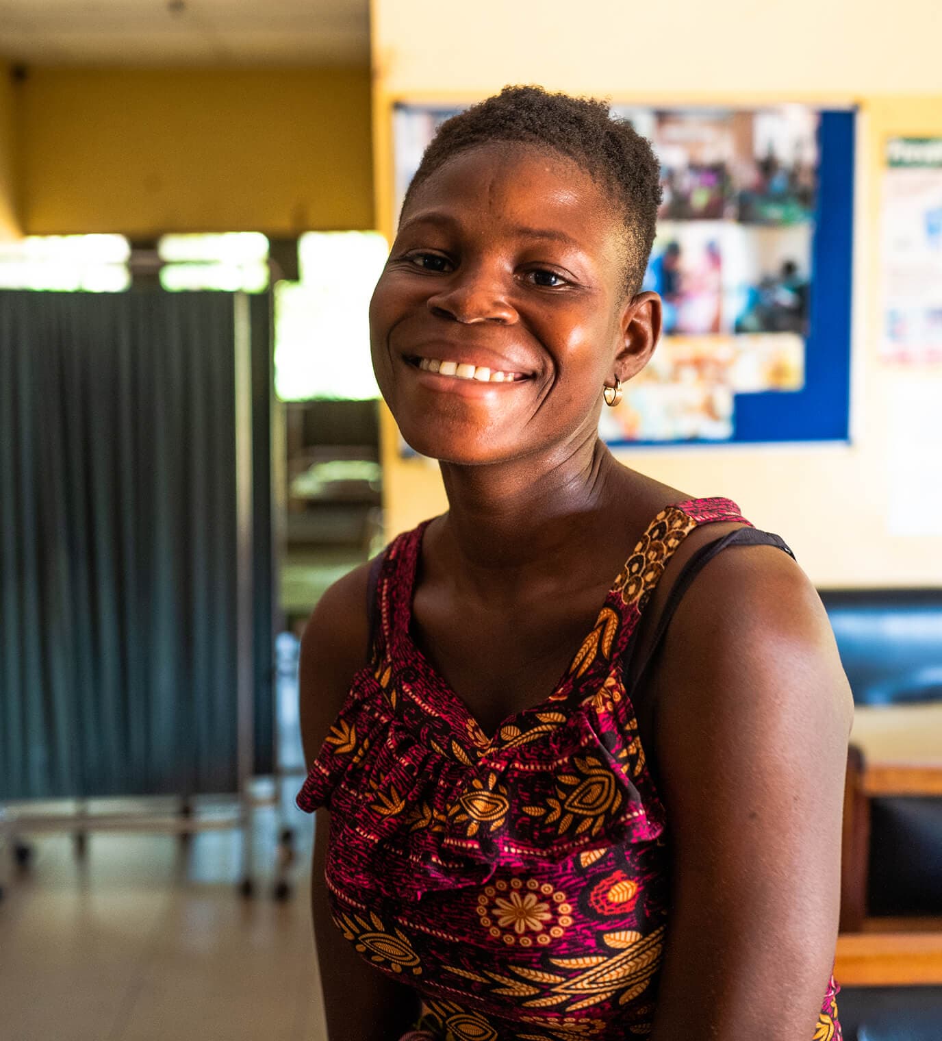 Person smiling in a healthcare facility.