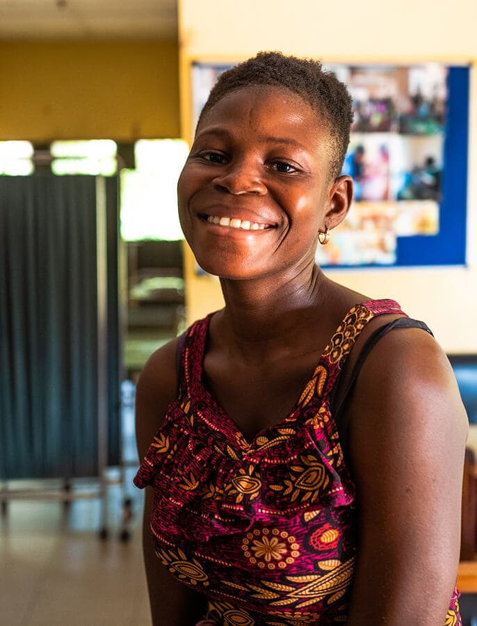 Person smiling in a healthcare facility.