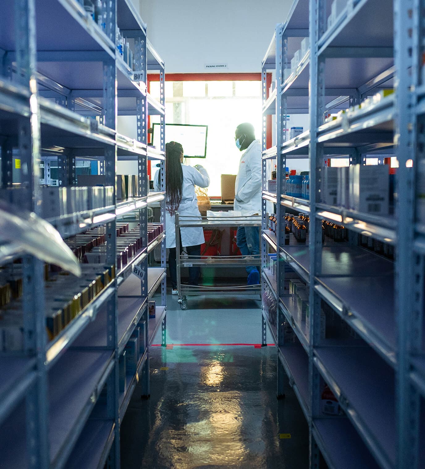 Two healthcare workers preparing orders in a medical supply warehouse.