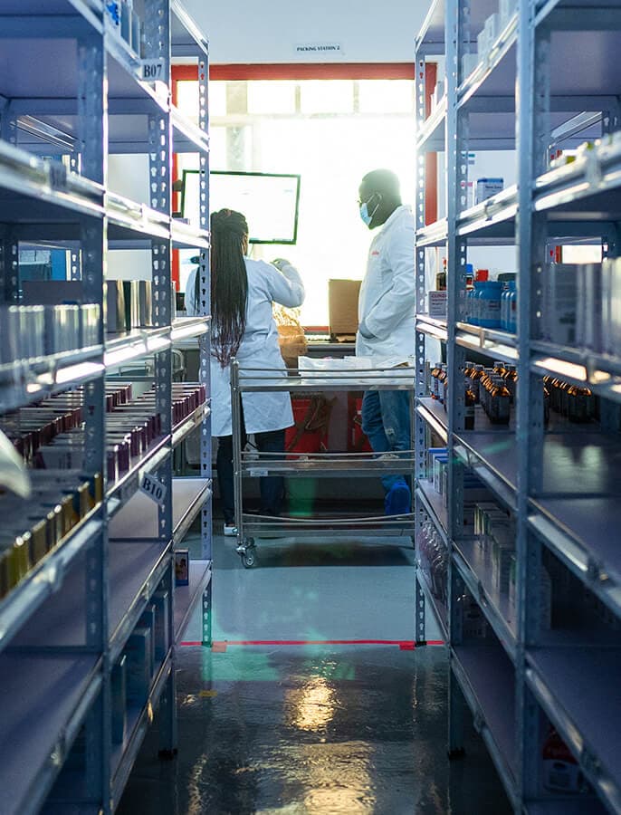 Two healthcare workers preparing orders in a medical supply warehouse.