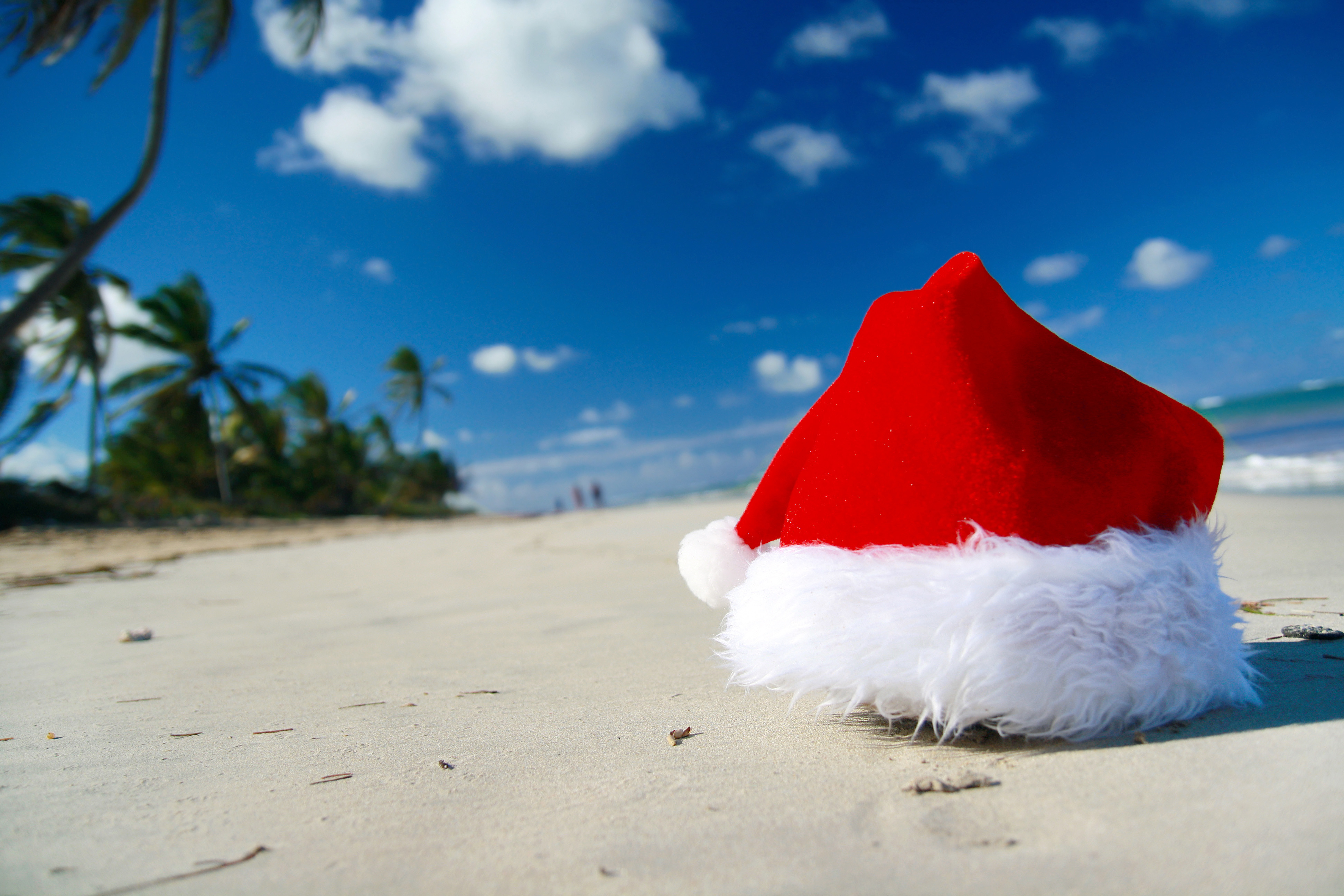 Santa Claus hat on a beach, closeup